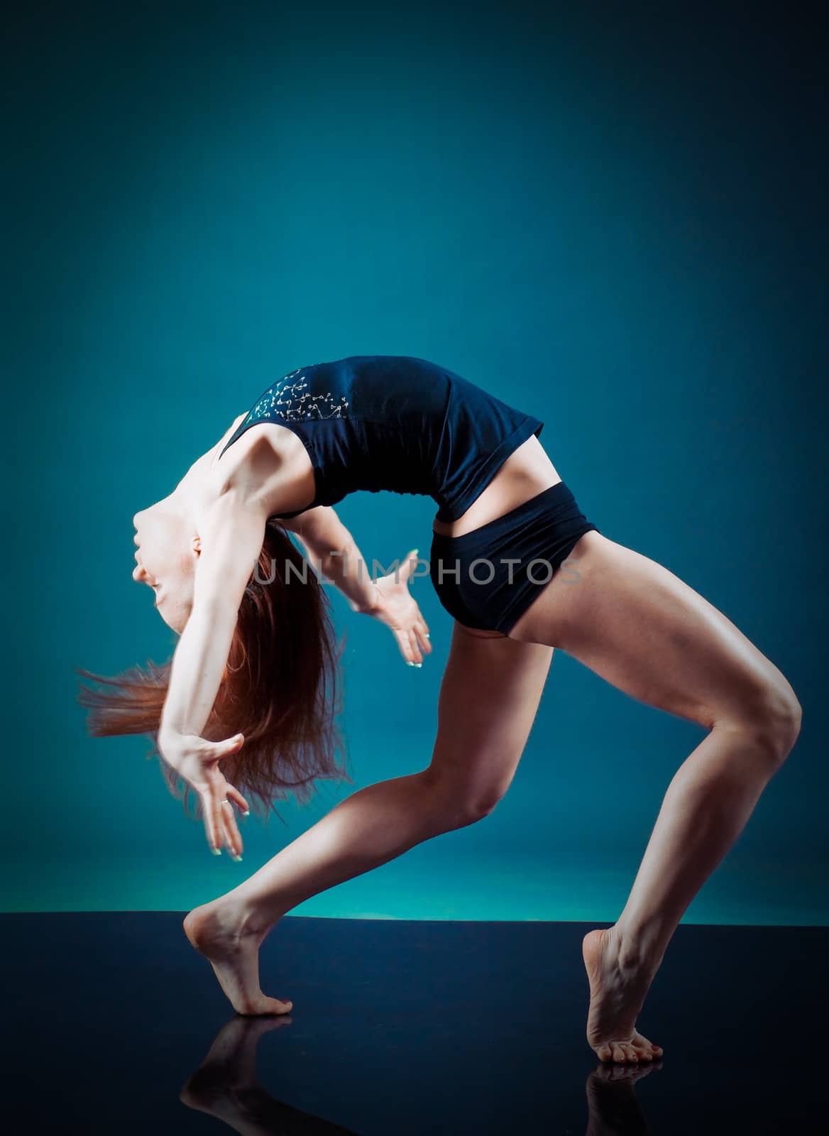 modern style dancer.female performing on  gray background