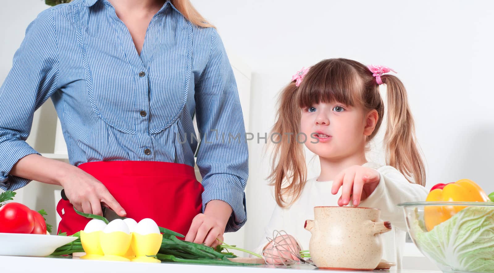 Mother and daughter cooking together, help children to parents