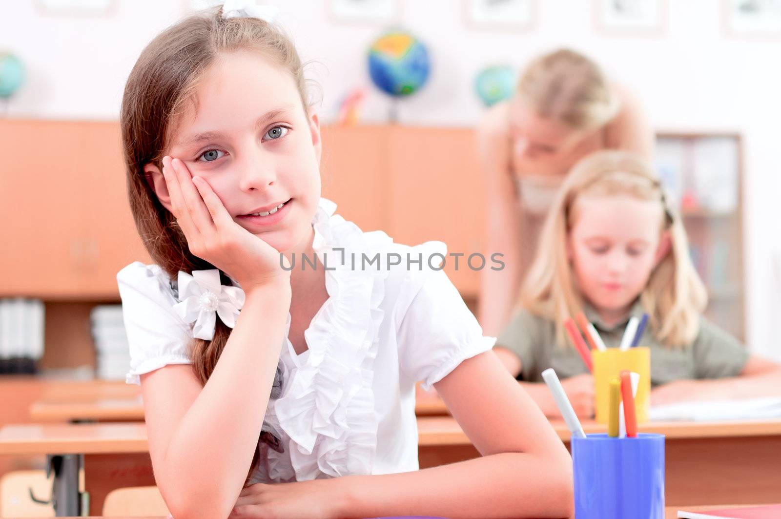 portrait of students in the classroom, sit at school desks