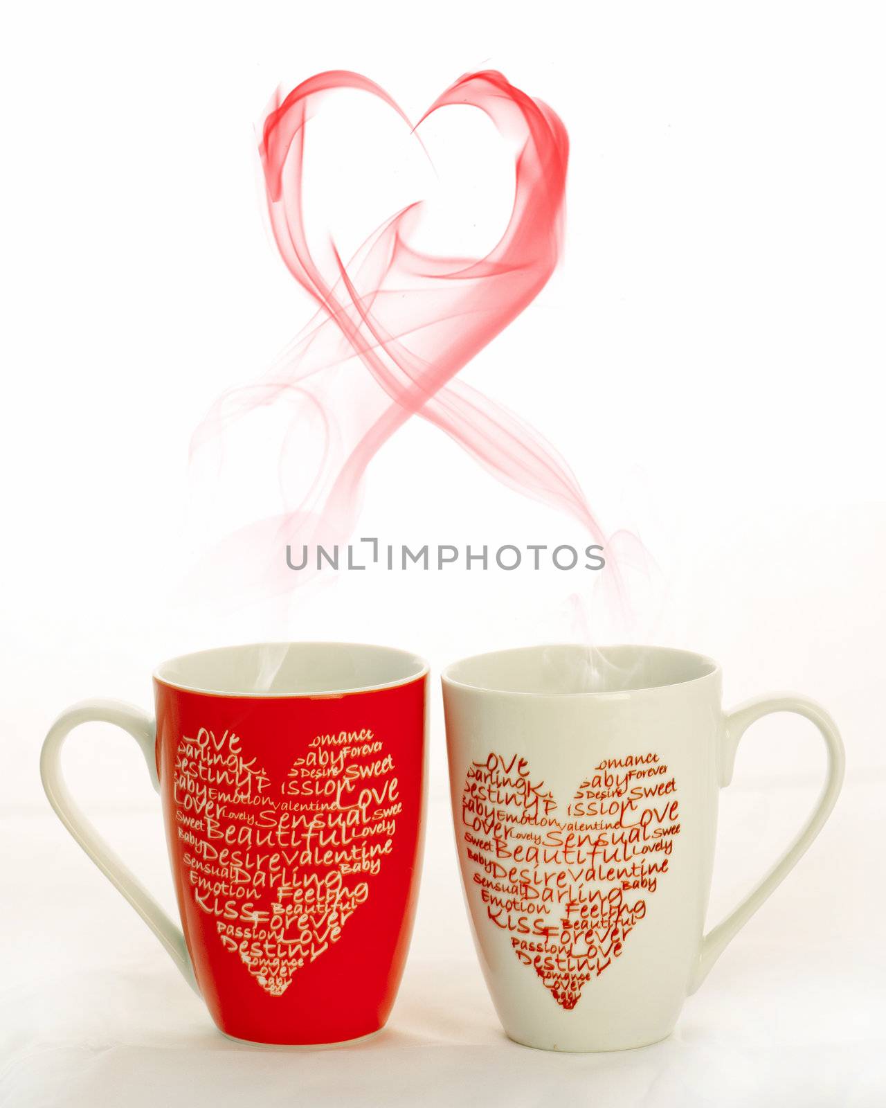 2 coffee cups with hearts creating smoke in the shape of a heart on a white background