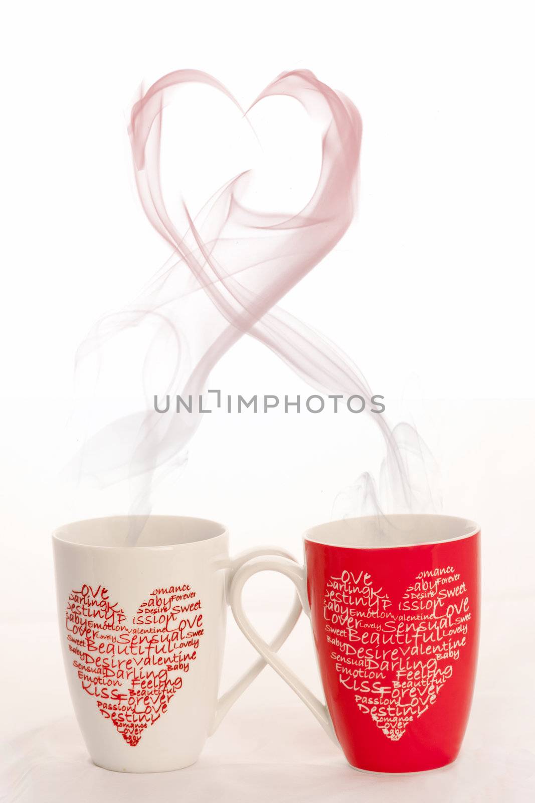 2 coffee cups with herats creating smoke in the shape of a heart on a white background