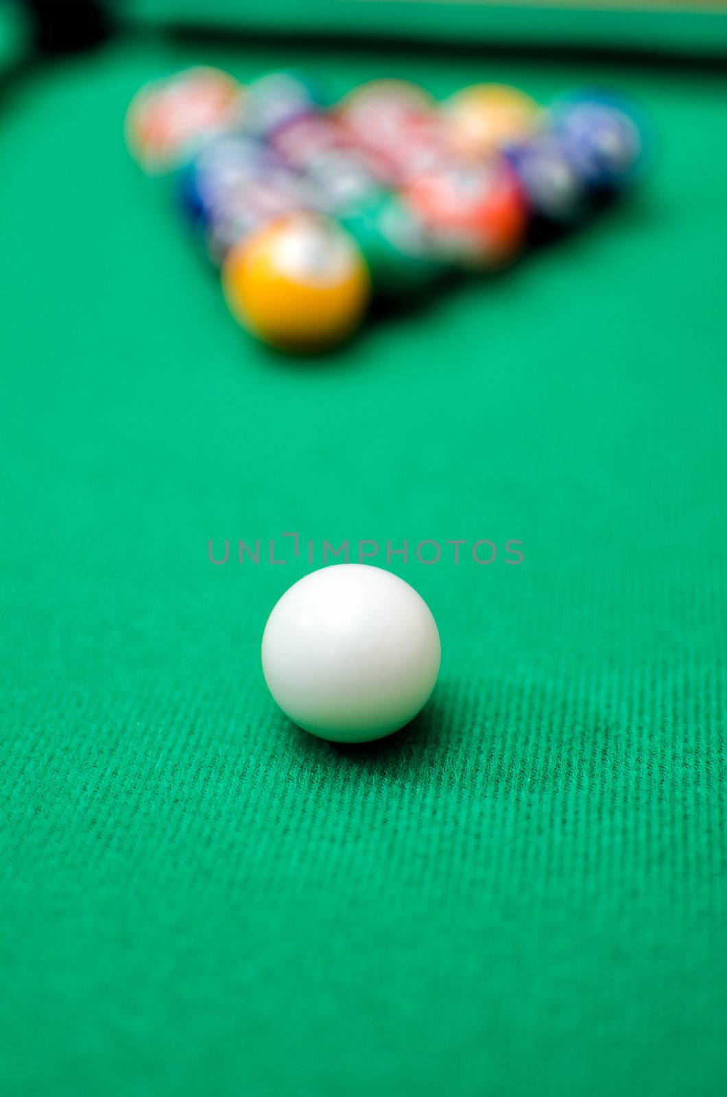 Pool game balls on green felt table by dmitrimaruta