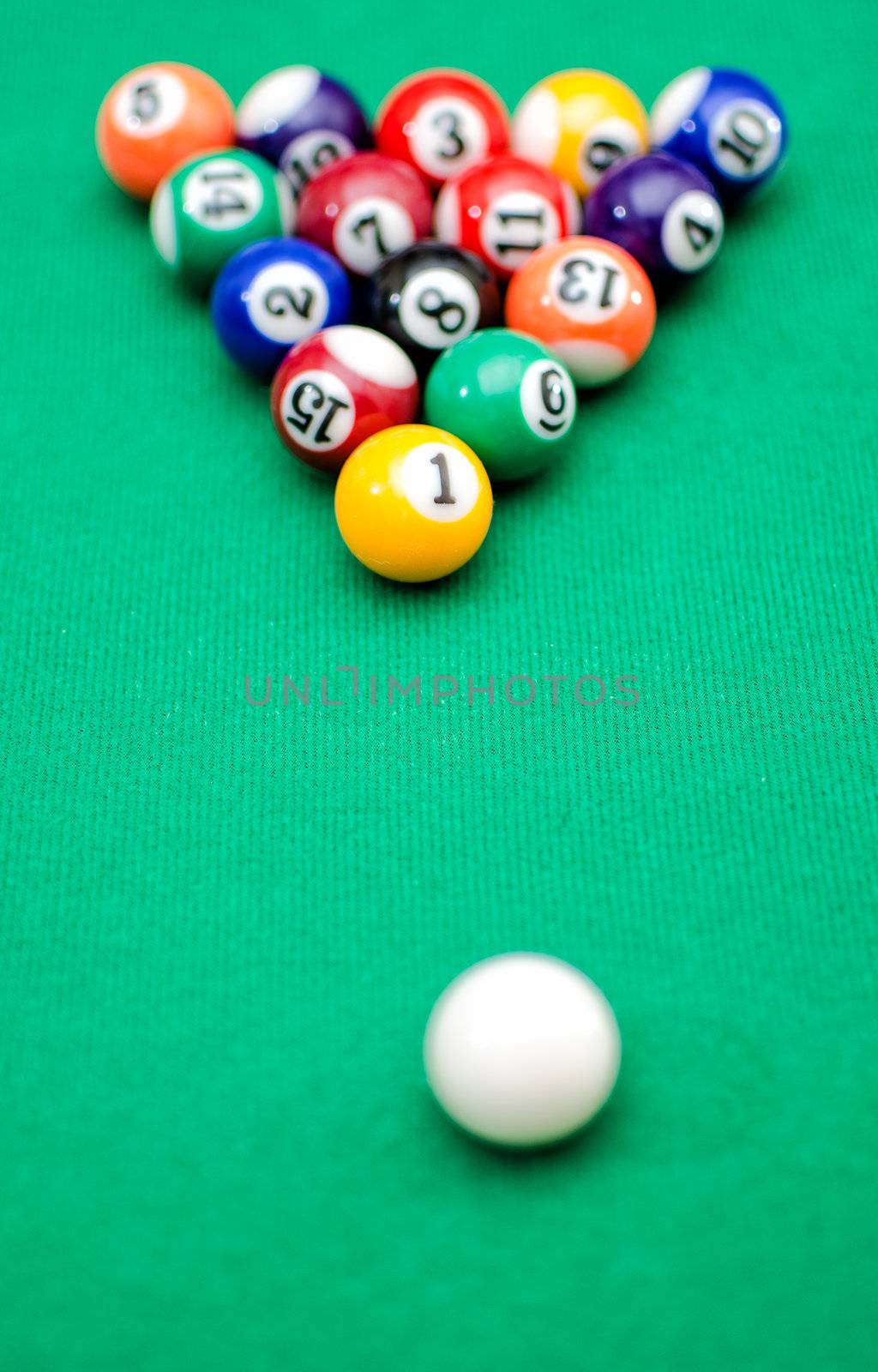 Pool game balls on green felt table by dmitrimaruta