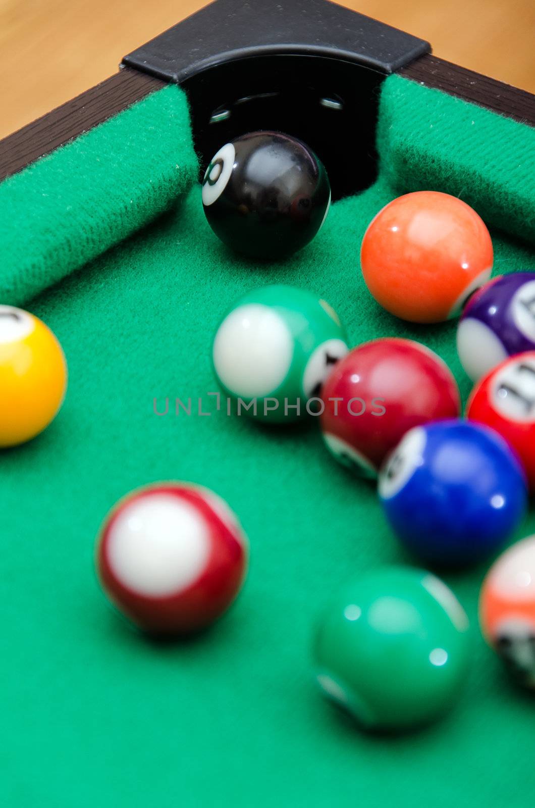 Pool game balls on green felt table by dmitrimaruta