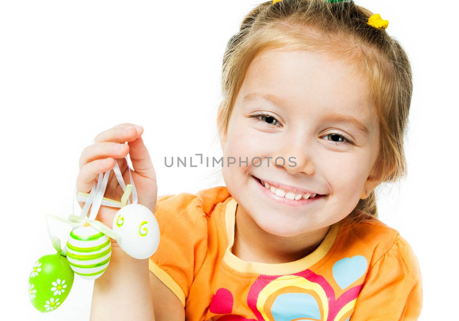 Smiling little girl with easter eggs. Isolated on white