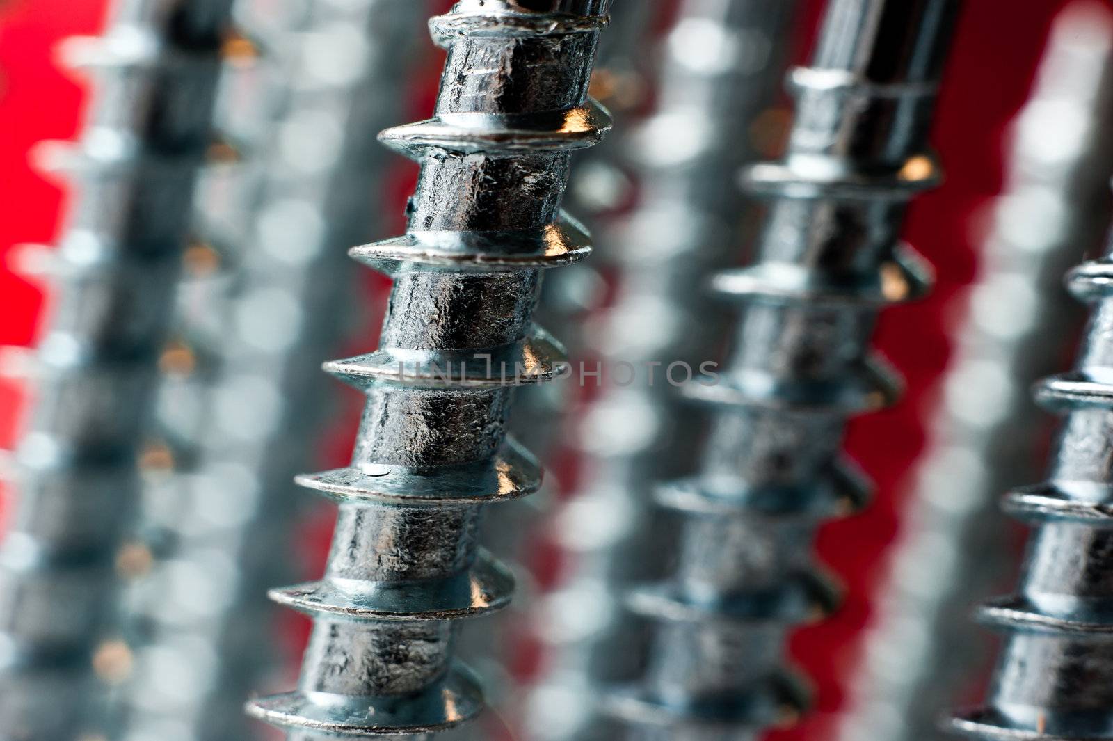 chrome screw on a blur red background