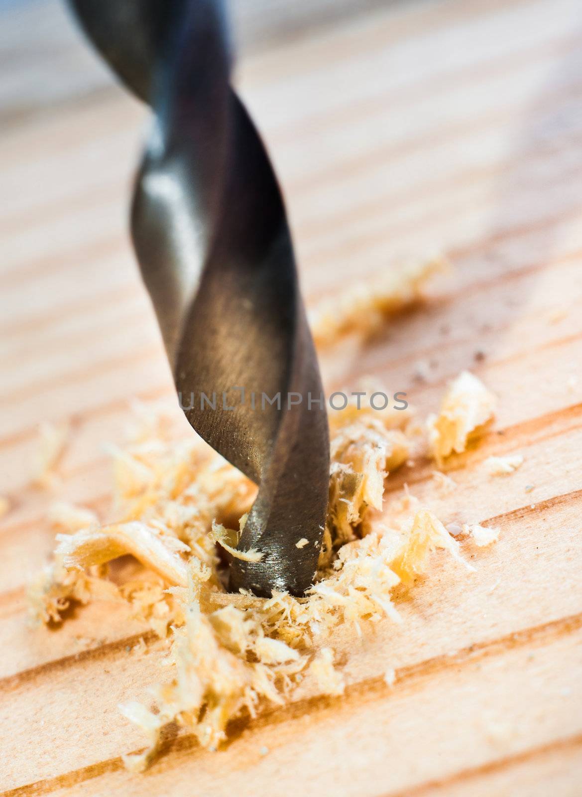 power drill bit closeup over wooden background