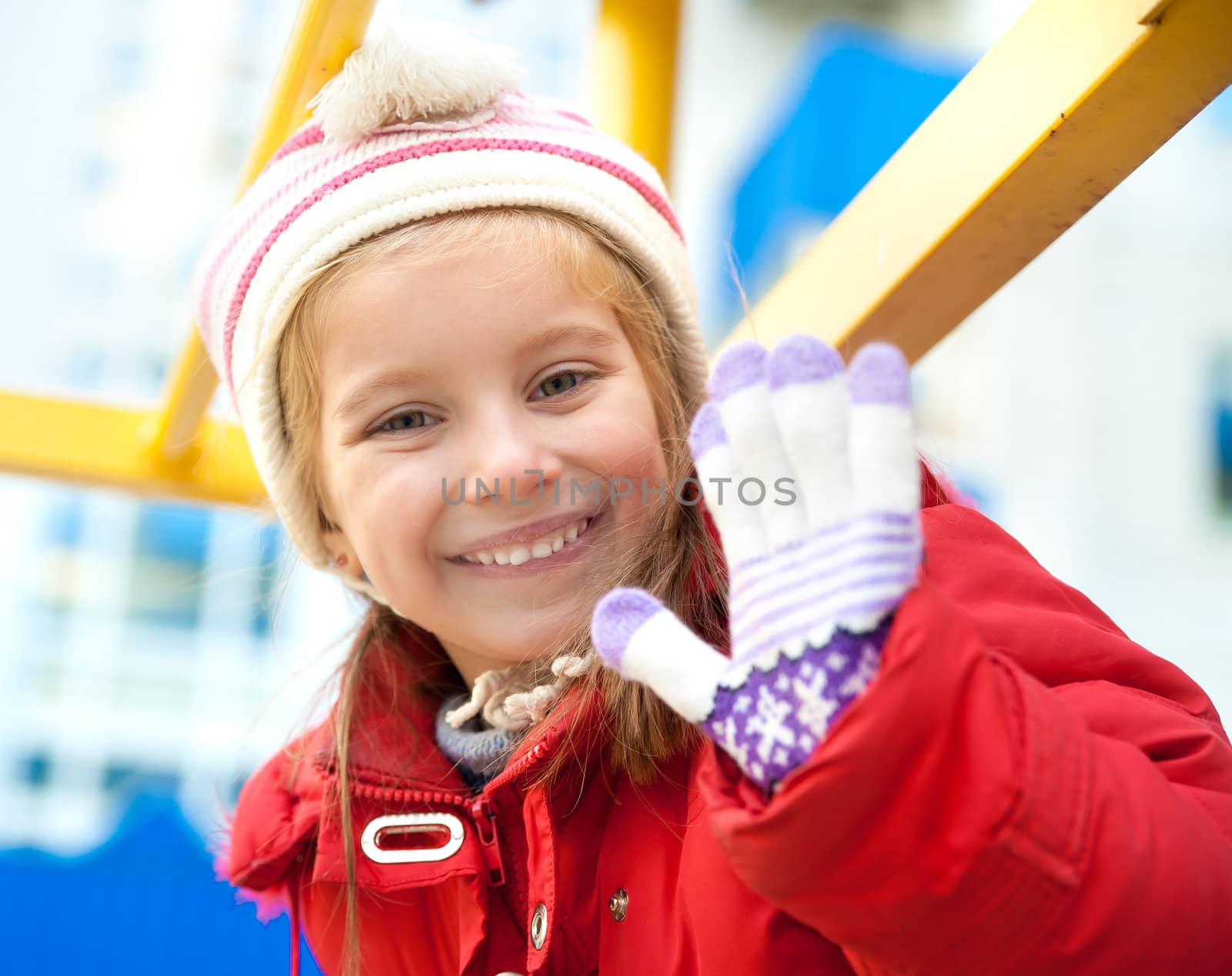 Smiling little girl on outdoor playground equipment