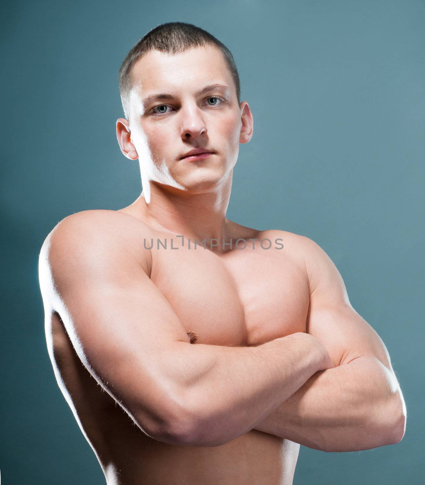 strong athletic man on grey background
