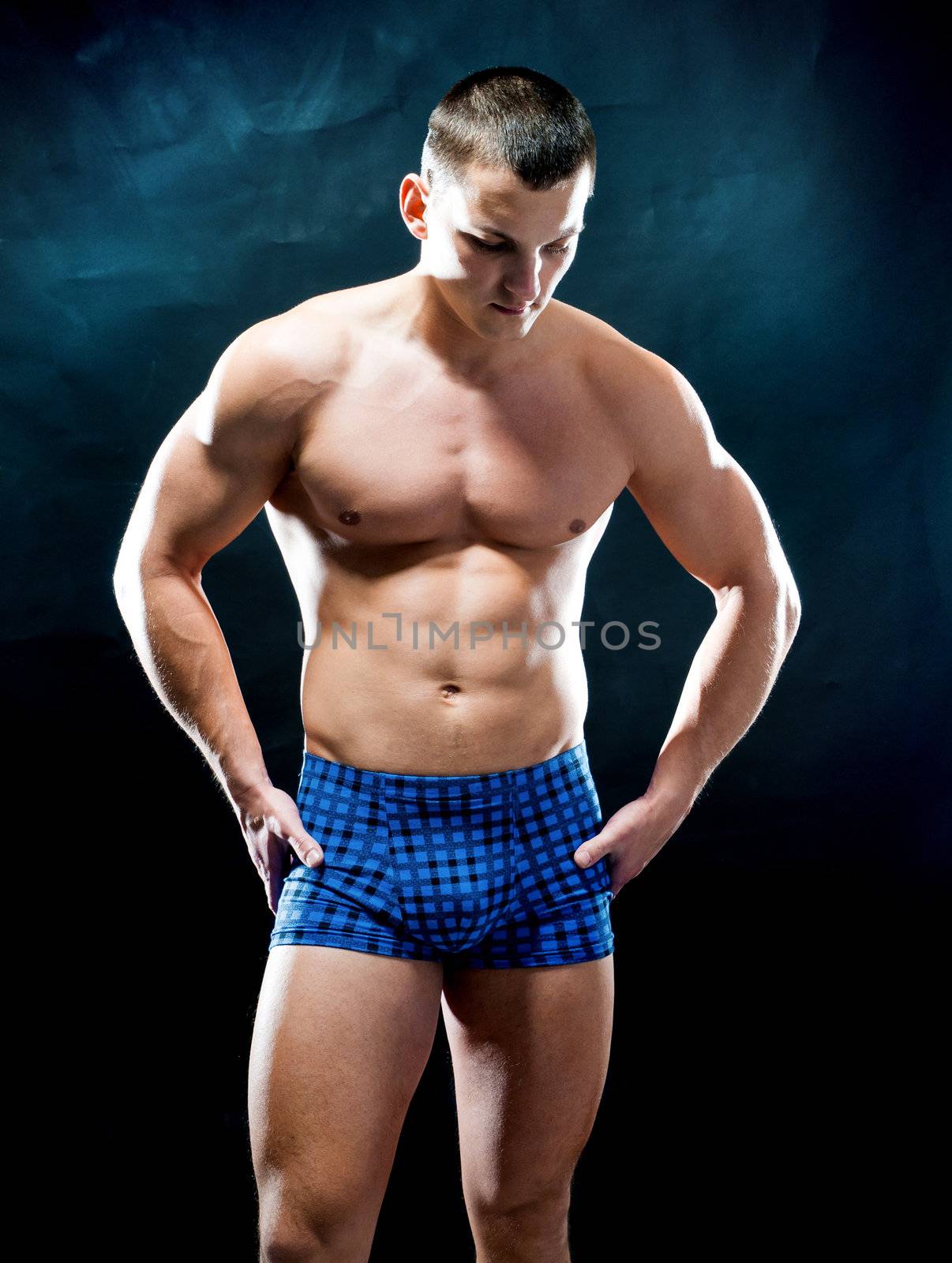 beautiful strong athletic man on black background