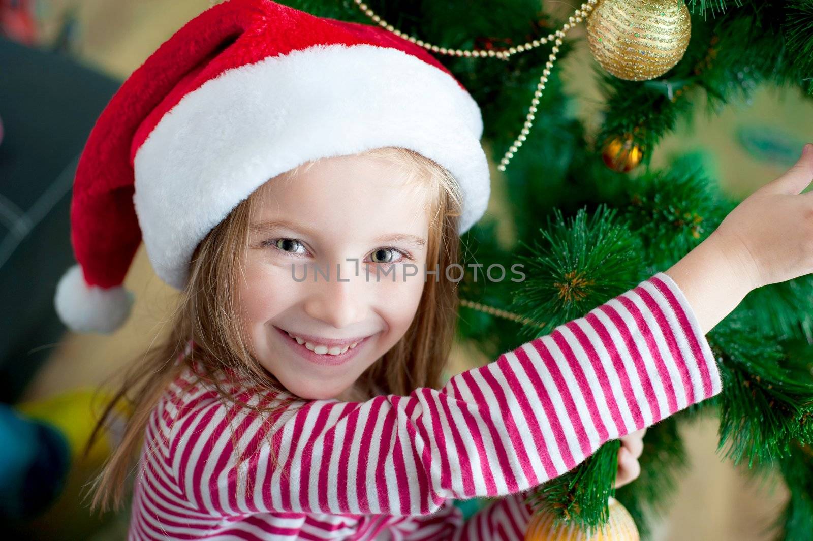 portrait of cute happy christmas child in santa hat closeup