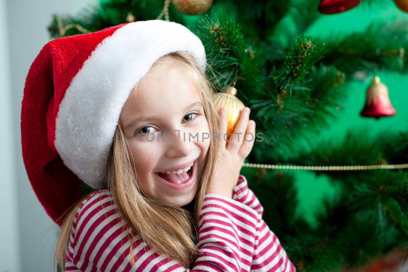 portrait of smiling christmas child in santa hat closeup