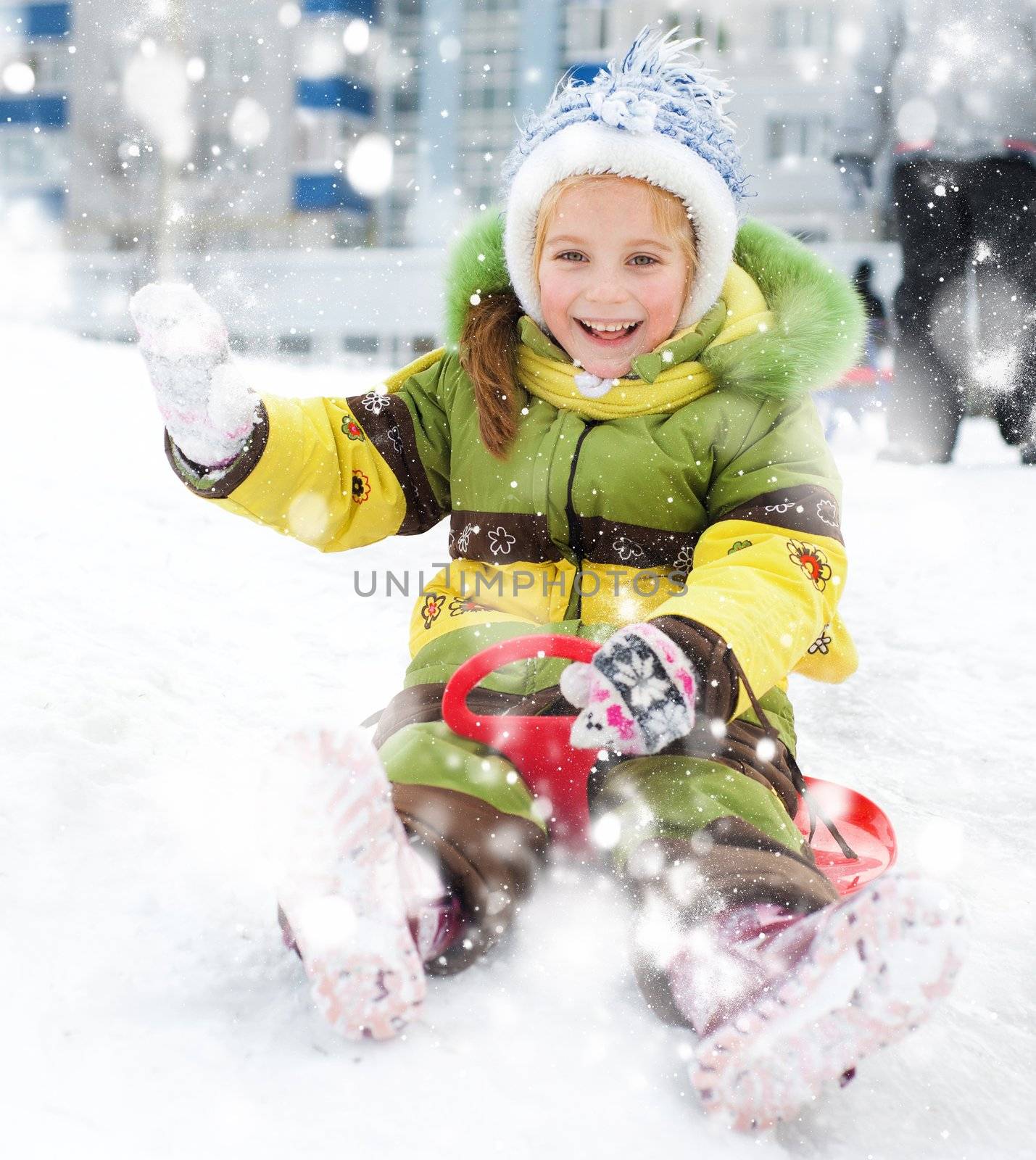 Happy child on sledge in winter