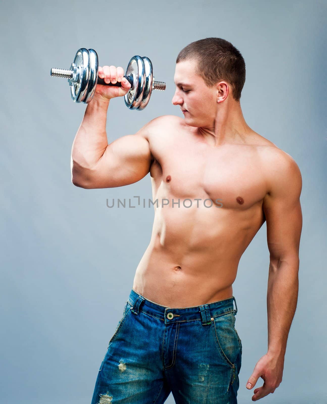 attractive athletic man with dumbbells in hand