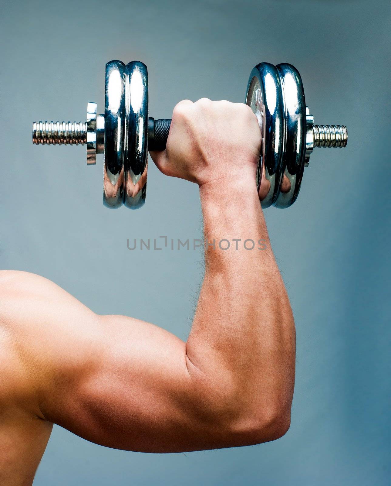 Arm attractive athletic man with dumbbells