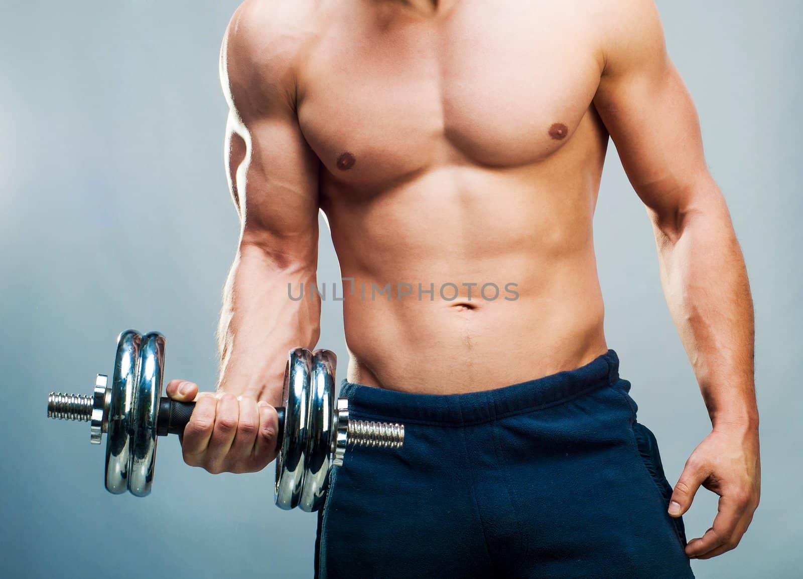 attractive athletic male torso with dumbbells
