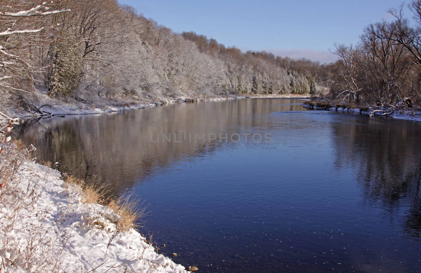 The Grand River with snow covering the banks.  Shot in Kitchener, Ontario, Canada.