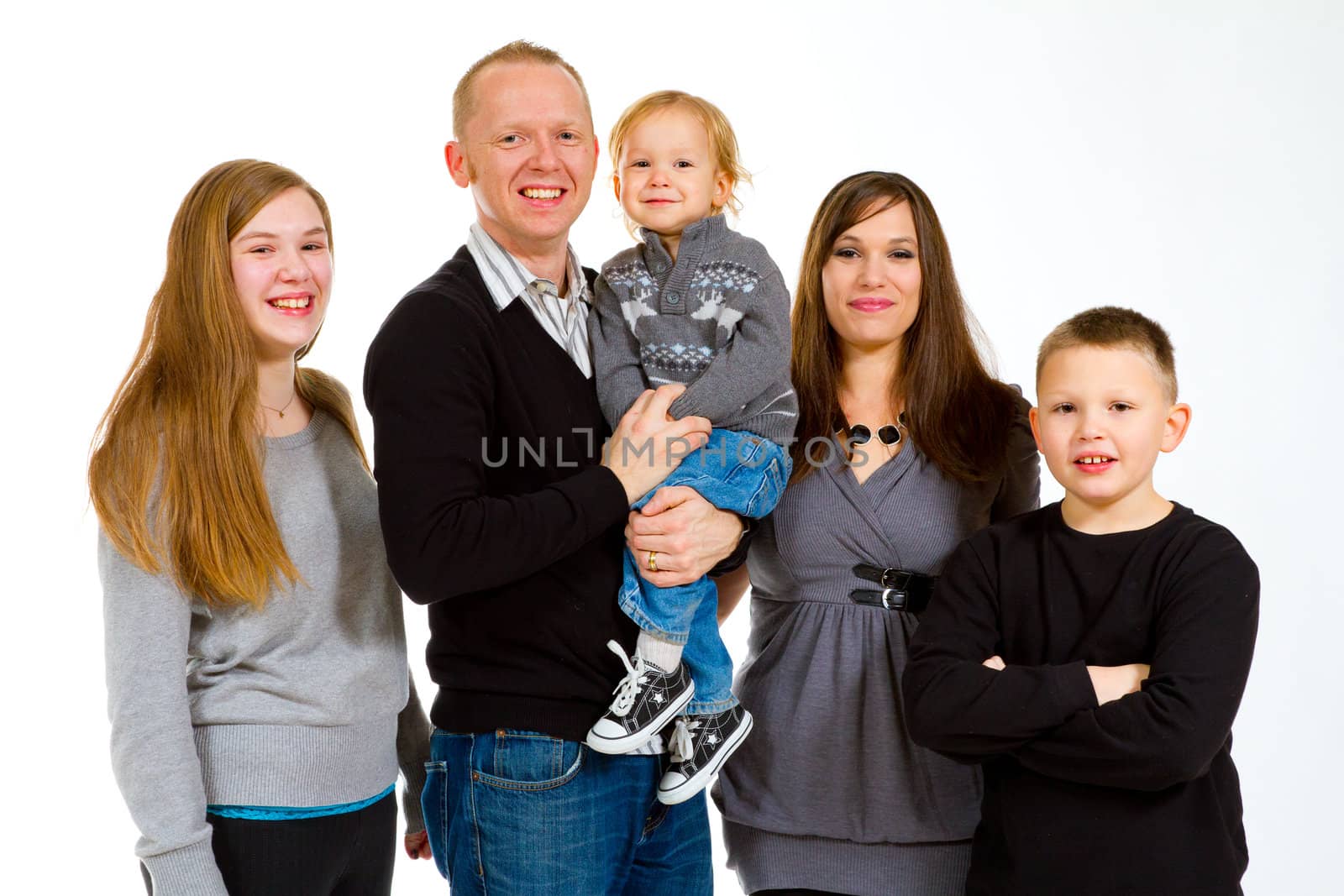 A family of five people on a white isolated background in the studio.