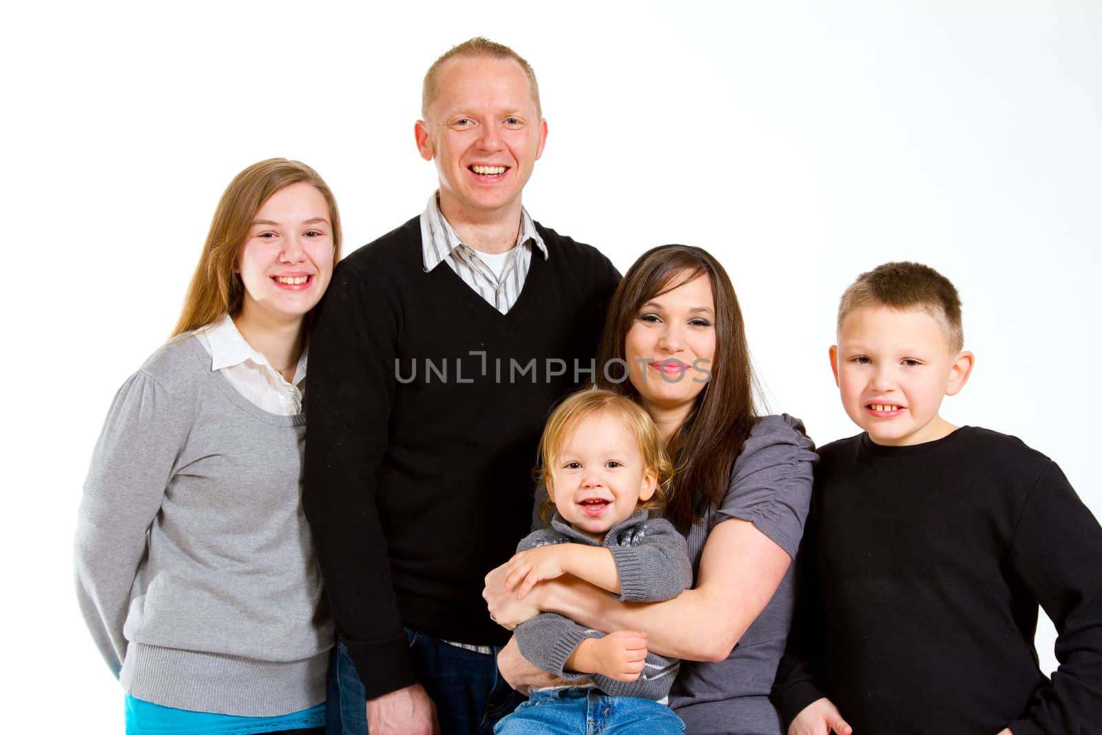 A family of five people on a white isolated background in the studio.