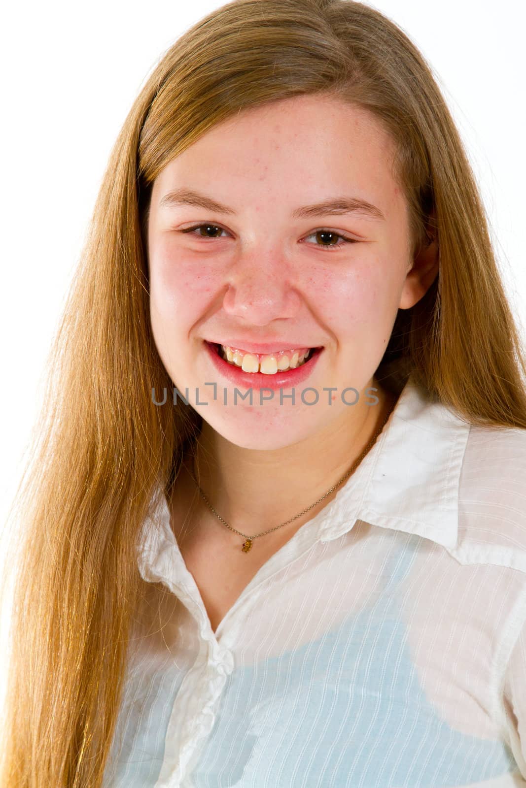 A young girl against a white background in the studio for a simple portrait.