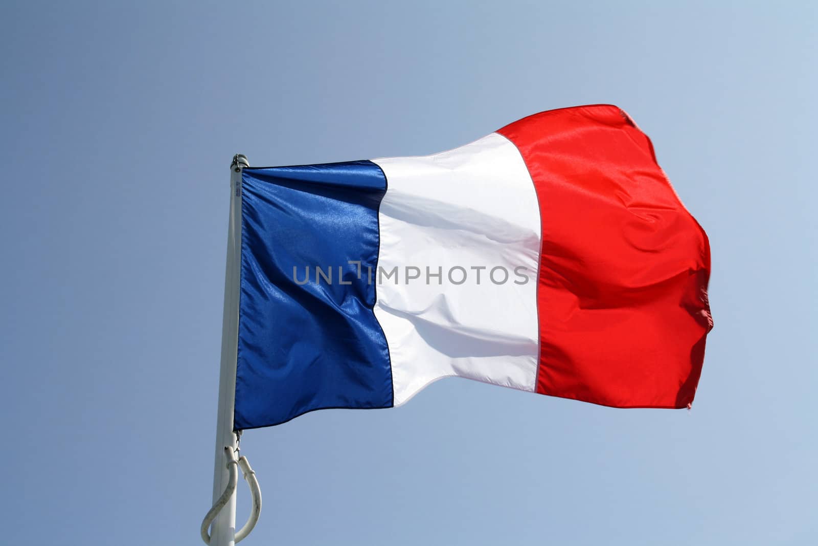 French flag waving firmly on its mast.