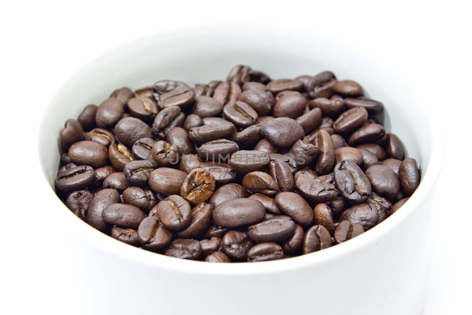 A cup and coffee beans on white background