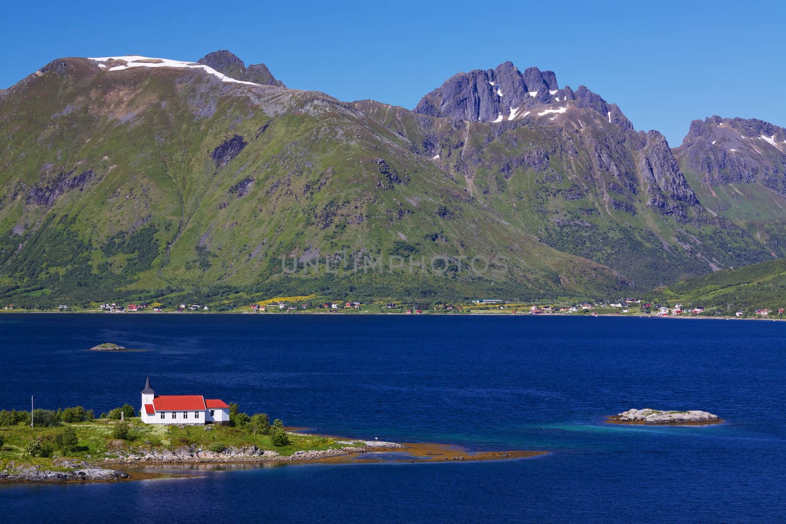 Scenic panorama with small church by fjord on Lofoten islands in Norway
