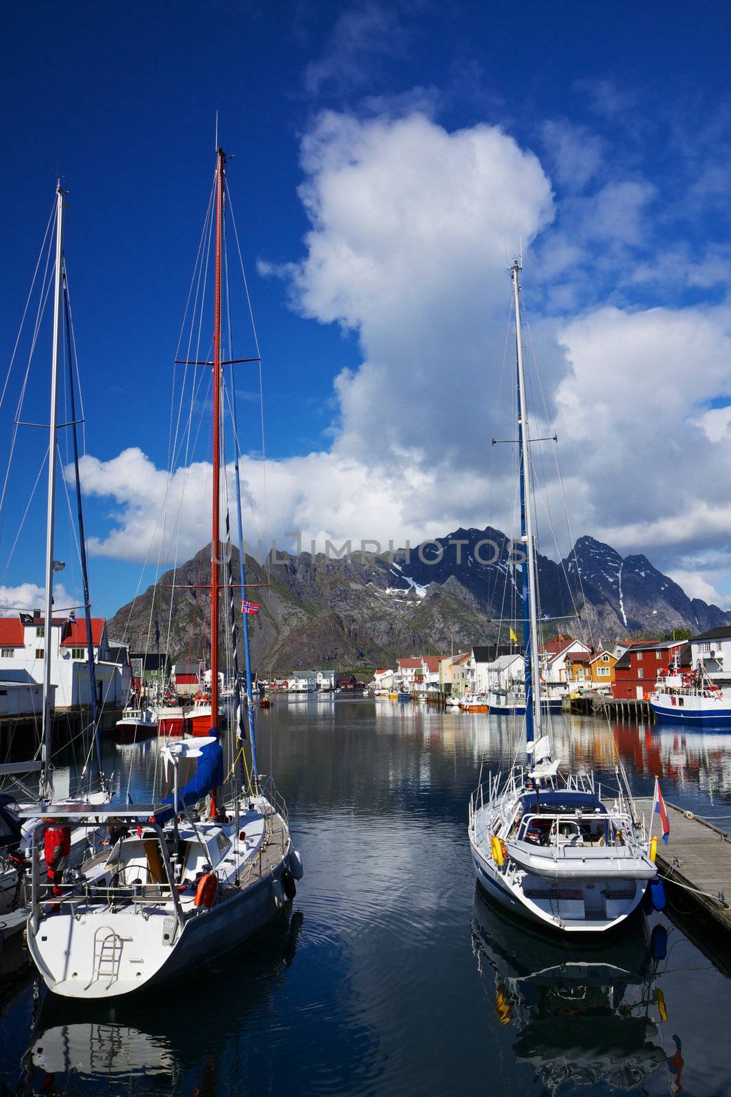 Yacht in picturesque harbor of Henningsvaer on Lofoten islands in Norway