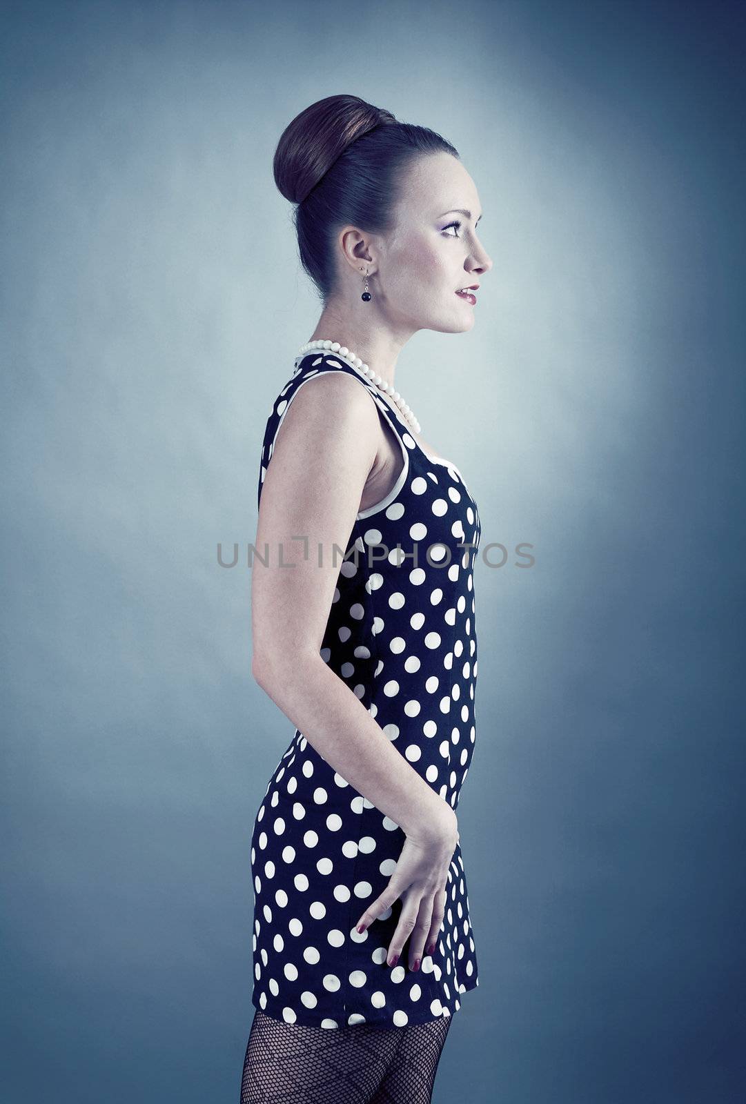 Girl in american 60s style in  polka dot dress