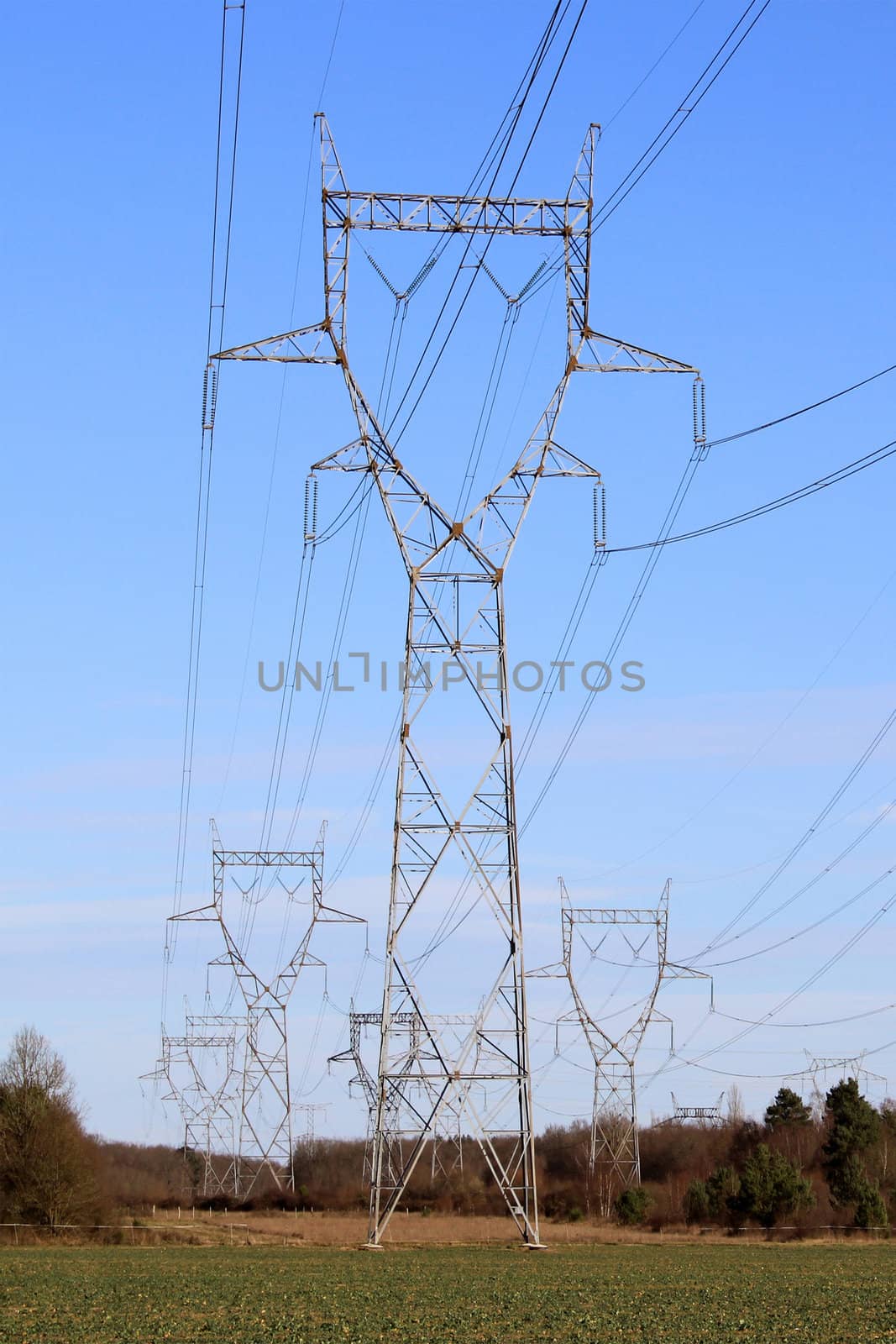 A row of electricity pylons in a field for a nuclear power
