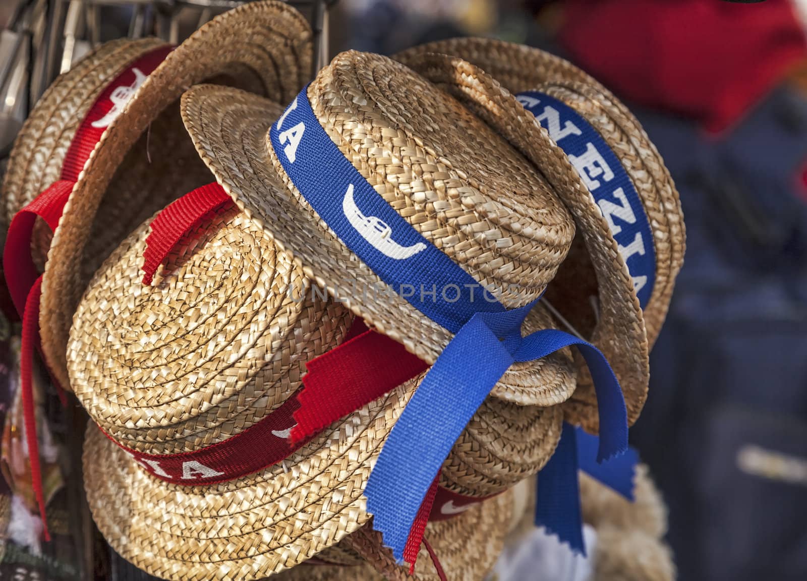 Traditional straws gondolier's hats on a stand of souvenirs in Venice.