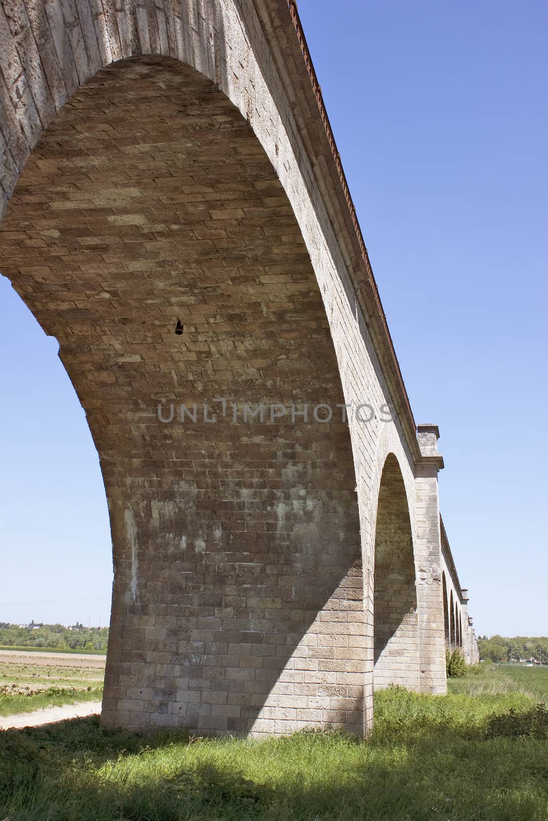 photograph of the viaduct of gien in a meadow