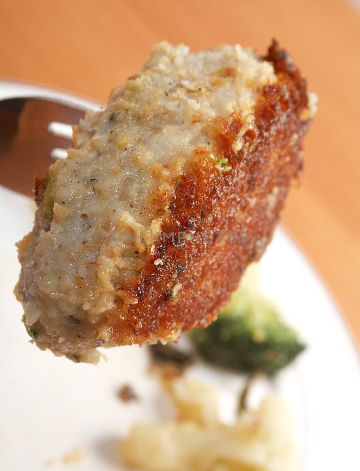 Cutlets in a plate with vegetables.Close-up .fork with chop