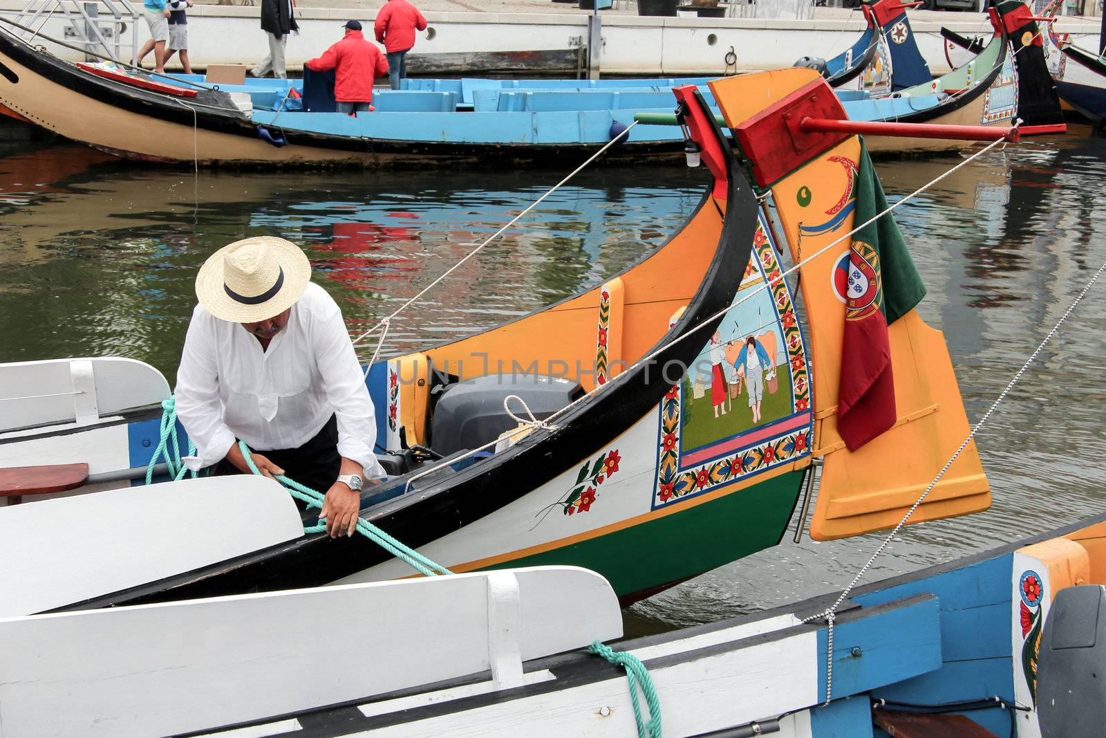 Portuguese sailor mooring traditional moliceiro boat in Aveiro,  by doble.d