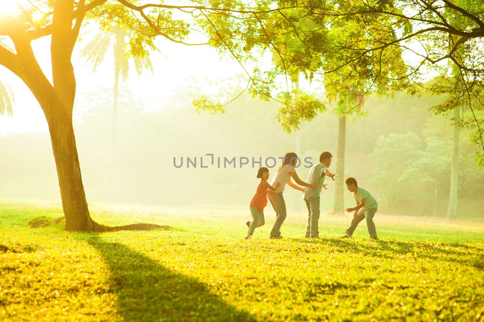 Asian family outdoor quality time enjoyment, asian people playing during beautiful sunrise
