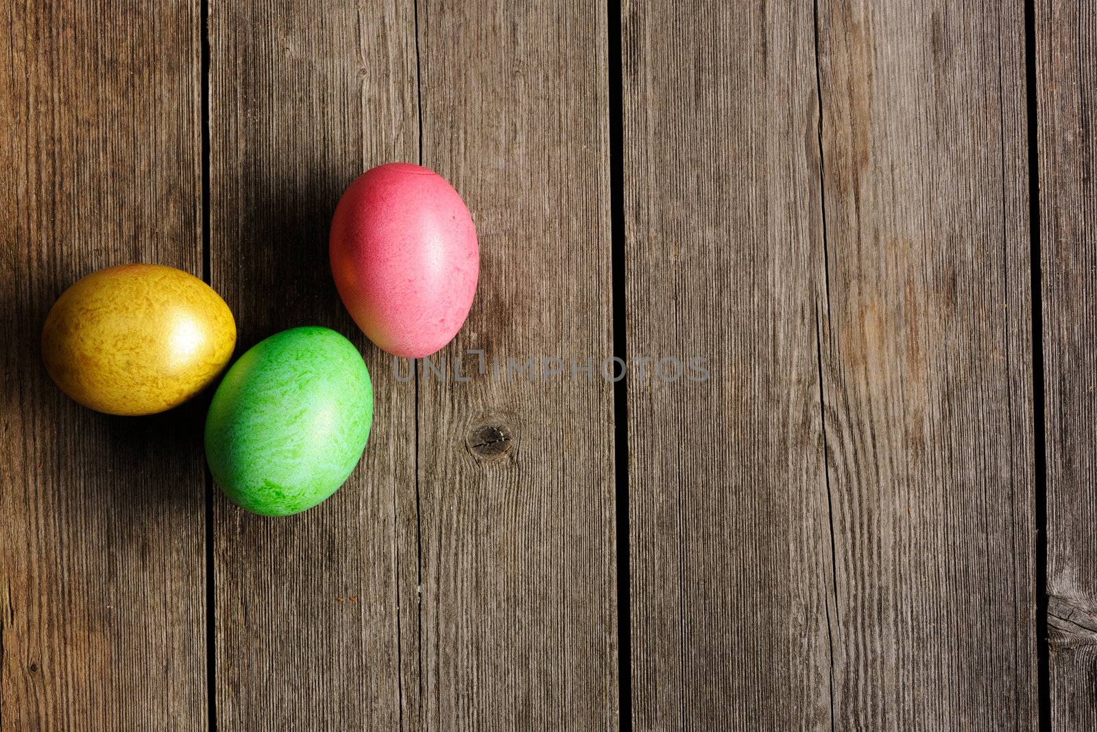 Colored easter eggs on wooden table