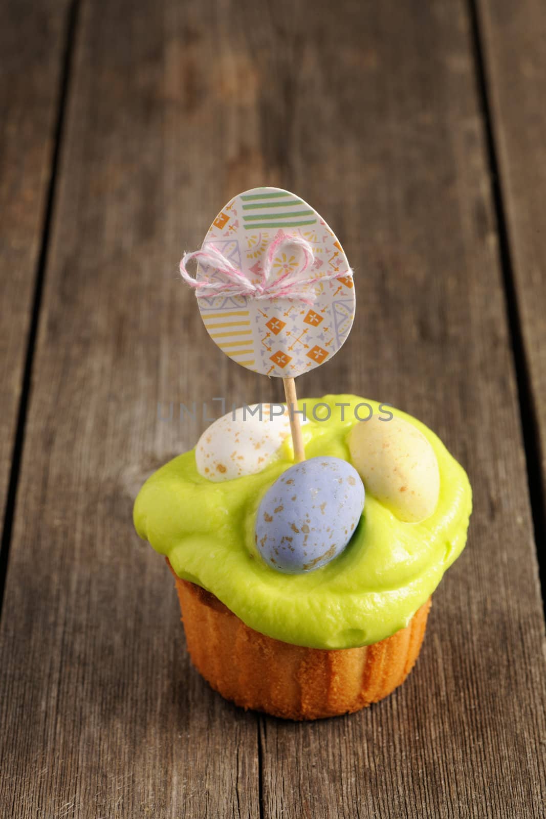 Easter homemade cupcake over wooden table