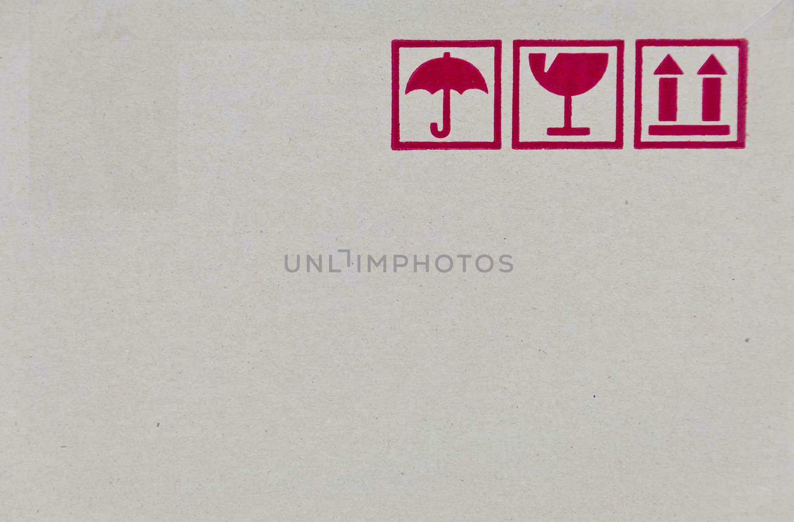Safety fragile icon on cardboard paper box with space
