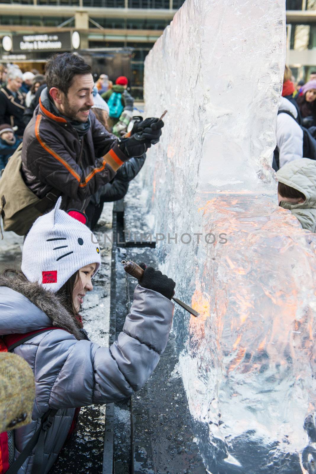 LONDON, UK - JANUARY 13: Public activity at the London Ice Sculpture Festival, in Canary Wharf. Visitors were invited to carve this block of ice. January 13, 2013 in London.