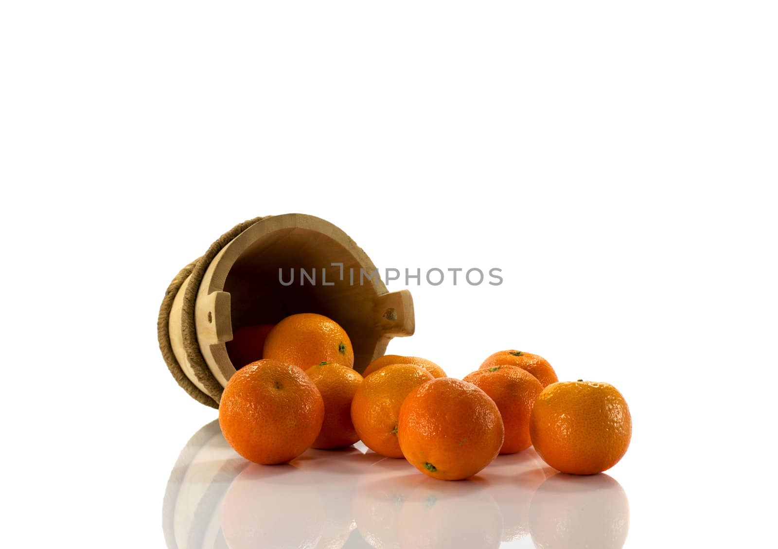 tangarines and wooden bucket, isolated on white