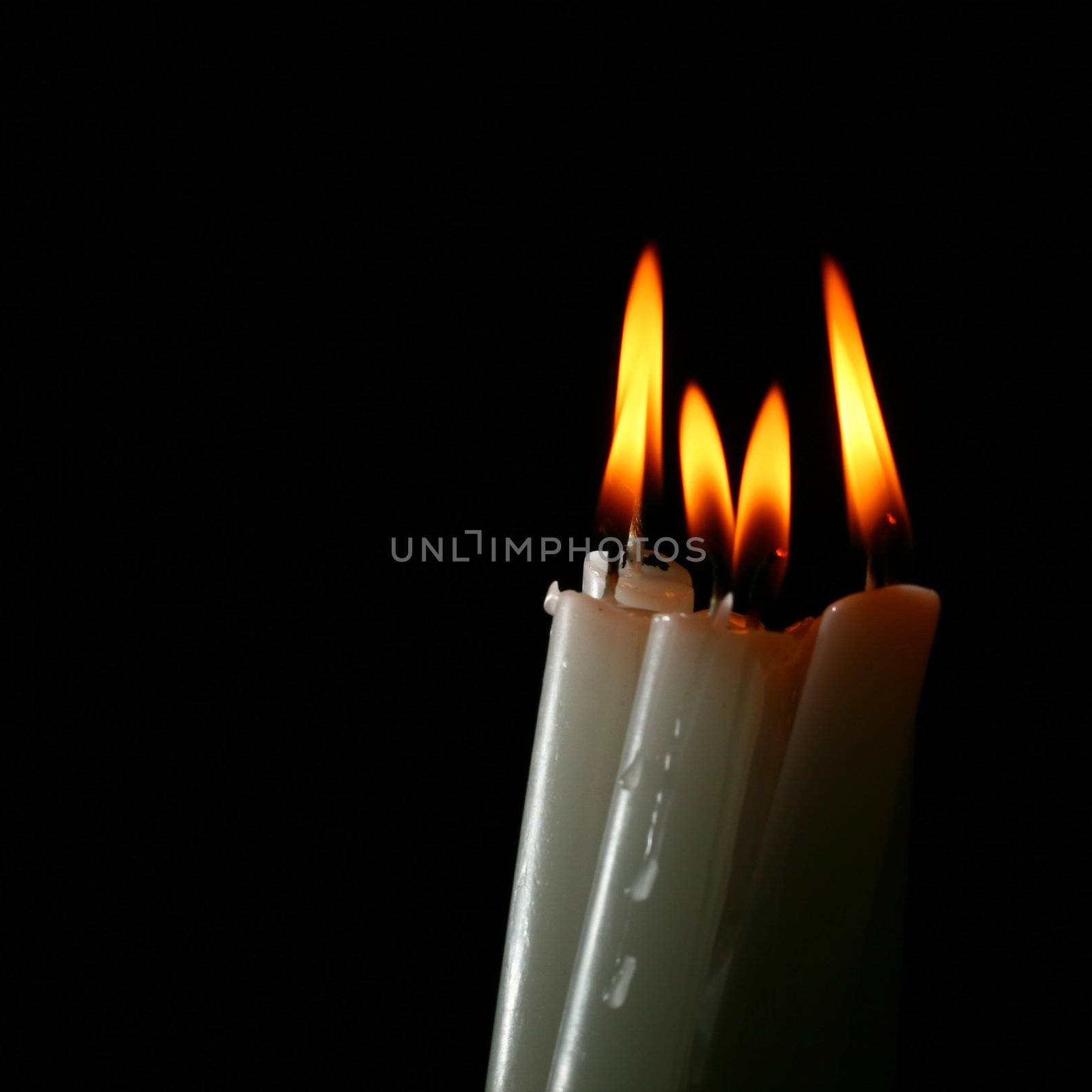 sacred candles in dark on black background