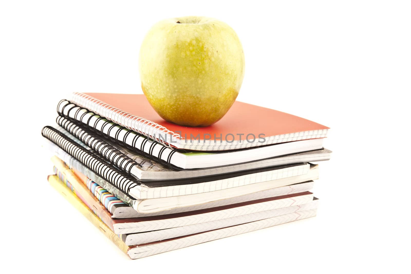 Notebook stack and apple. Schoolchild and student studies accessories. Back to school concept.