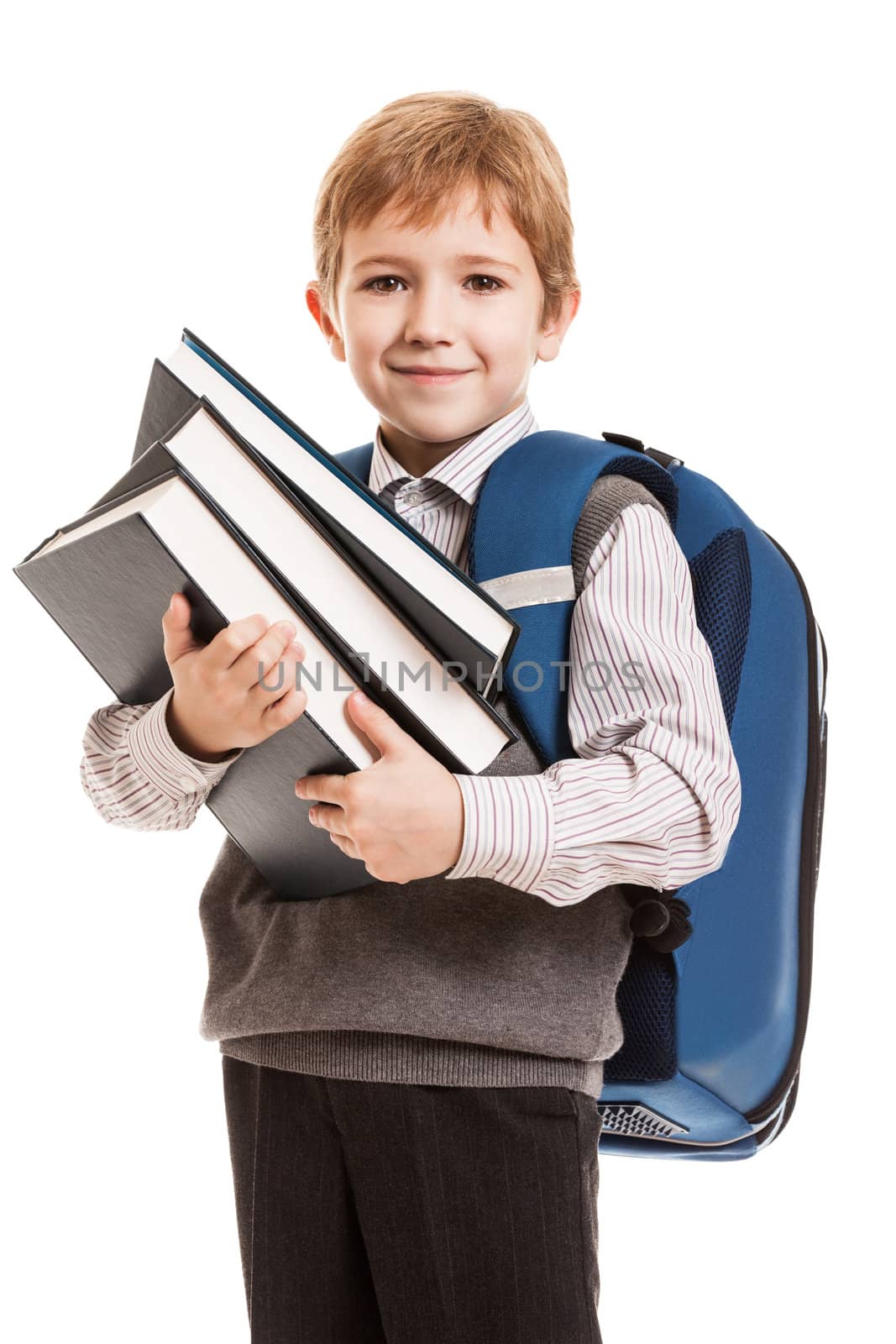 Little smiling child boy with school backpack holding education books in hands