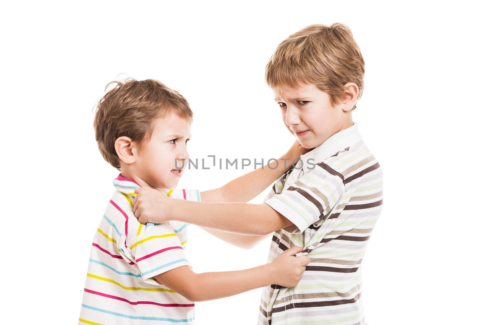 Two little displeased child boy brothers fighting in family conflict
