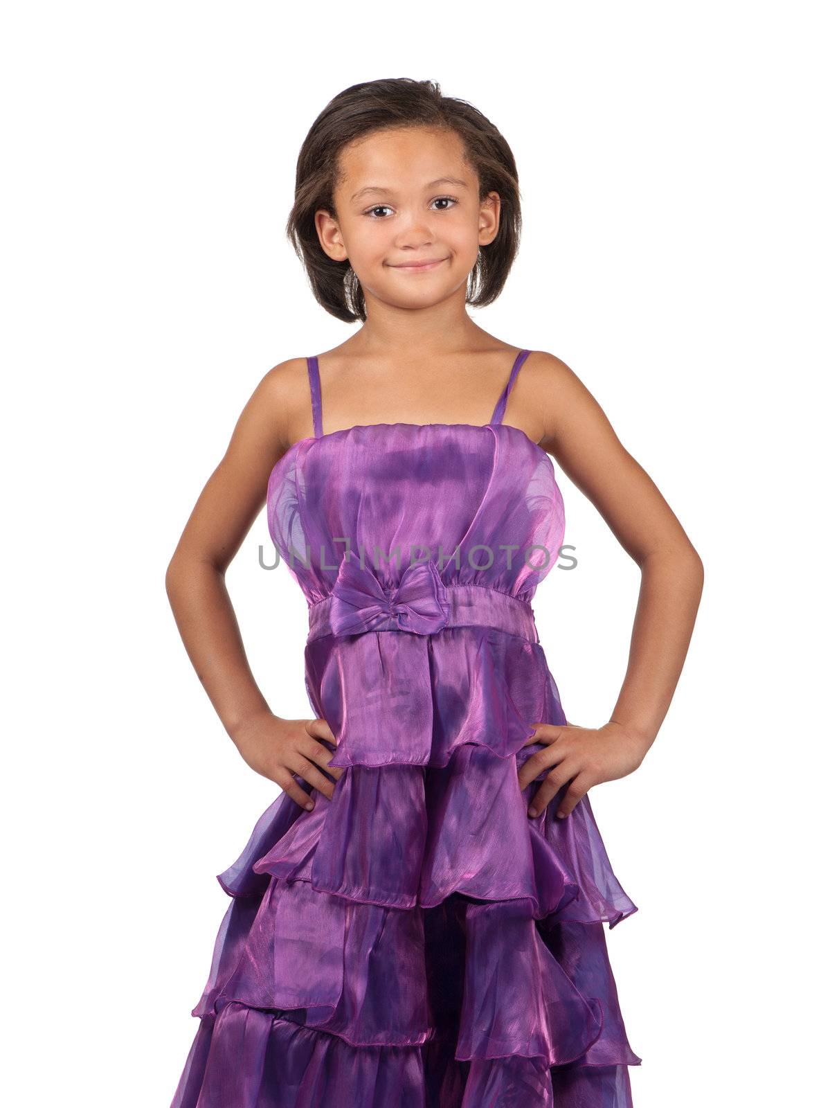 A happy young girl poses in a purple dress.