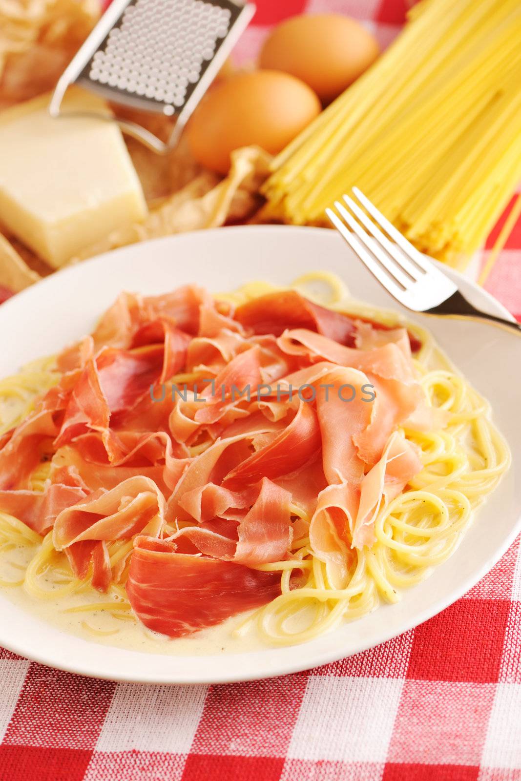 Pasta carbonara over red cloth