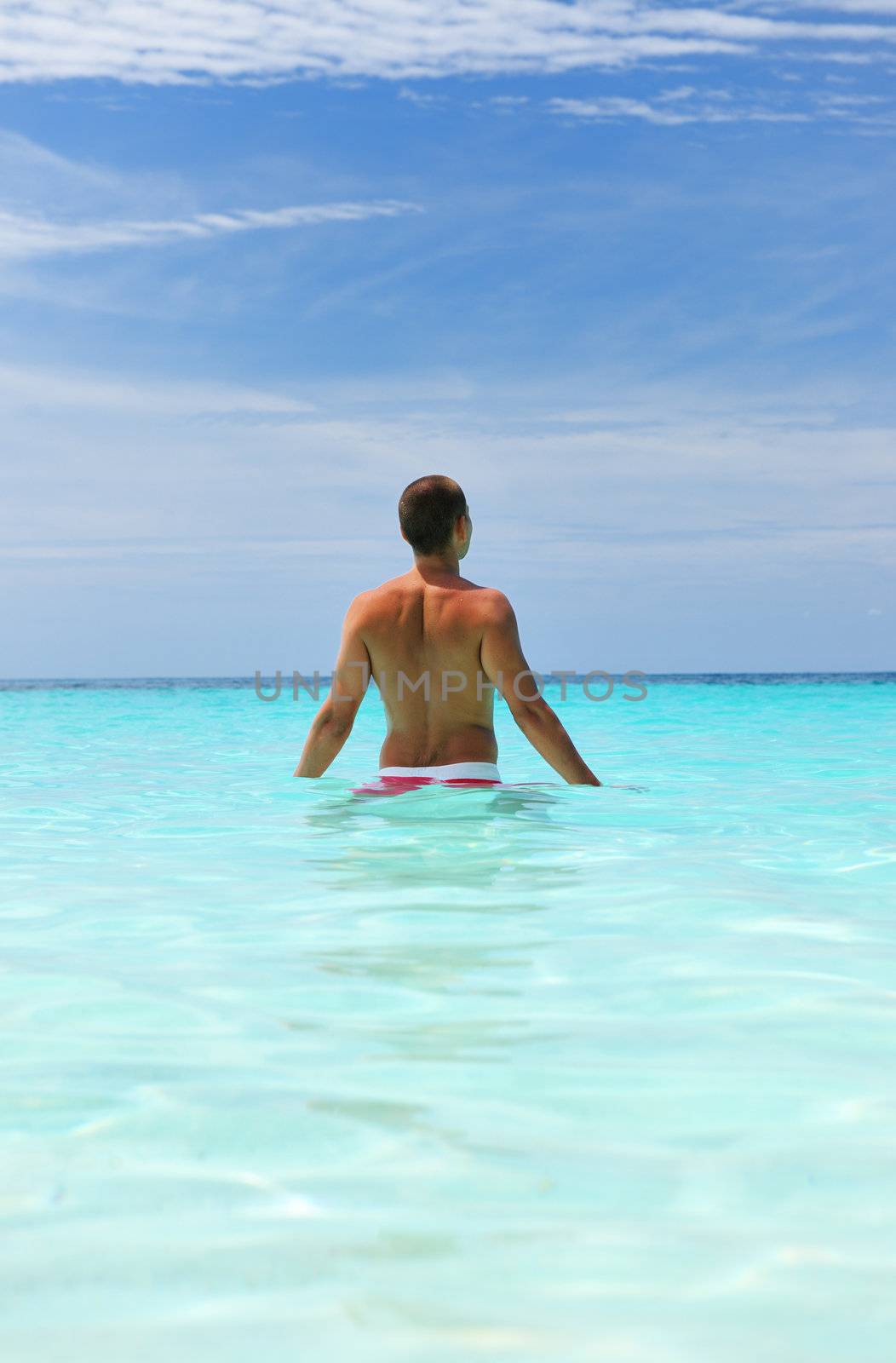 Man in water at tropical beach