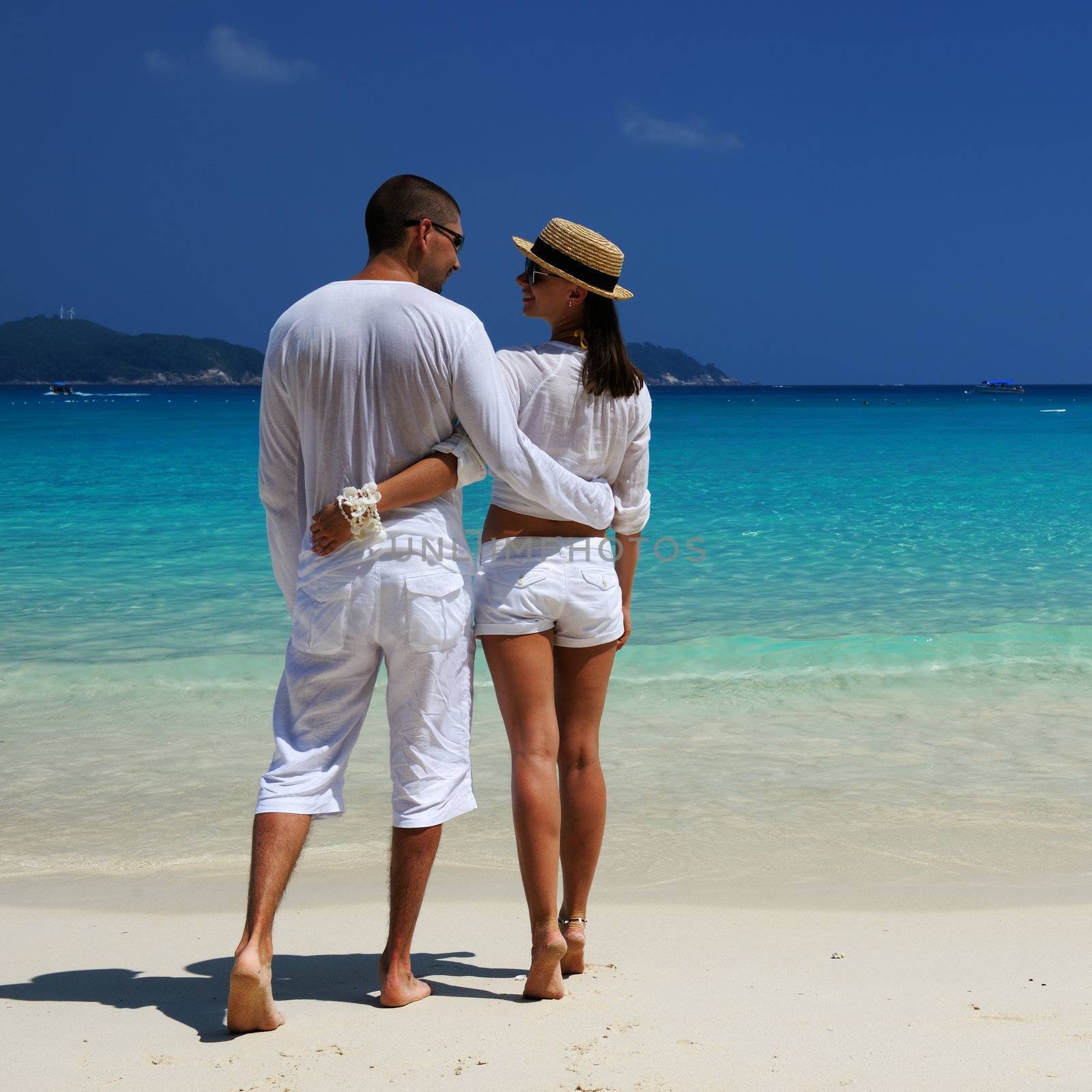 Couple in white on a tropical beach