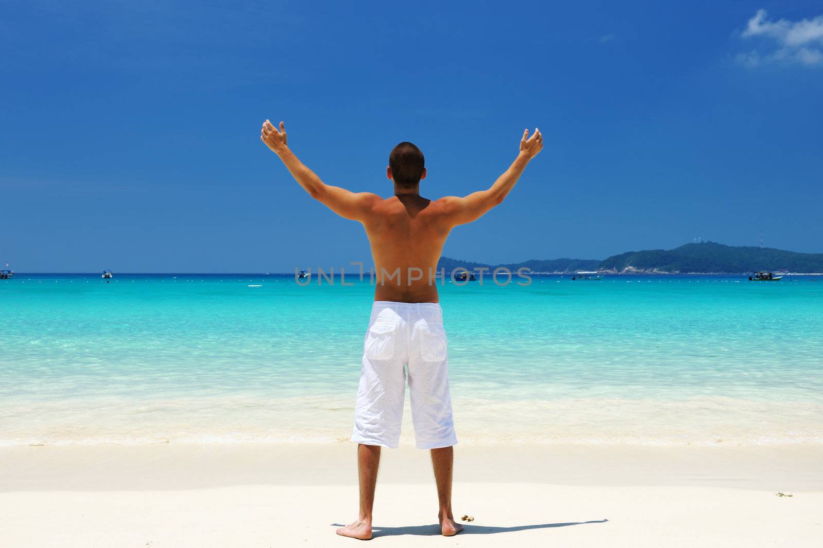 Man in white at tropical beach