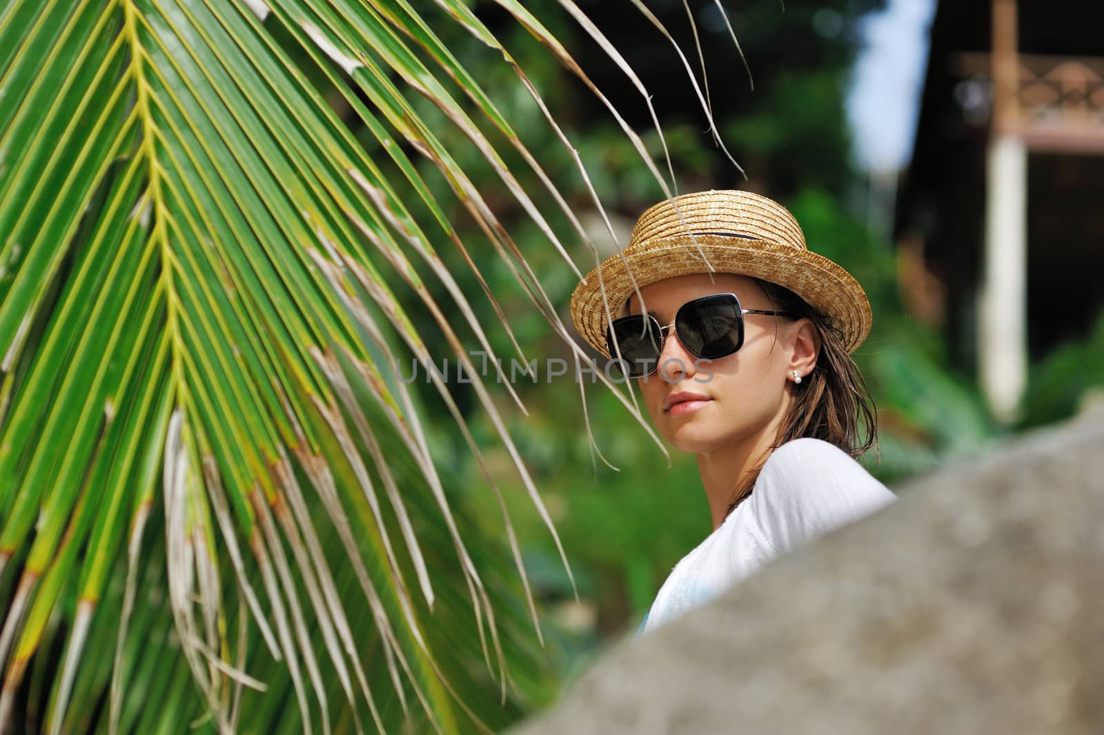 Woman in sunglasses near palm tree by haveseen